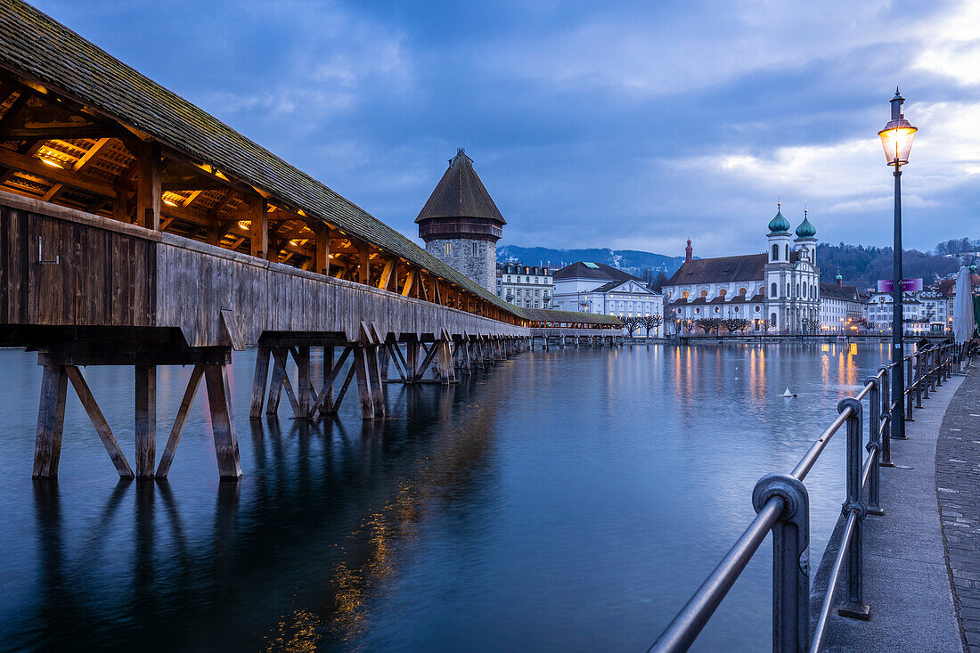 View of the Kapellbrücke bridge, the Jesuit Church and the Wasserturm reflected on the Reuss river. Lucerne, canton of Lucerne, Switzerland.