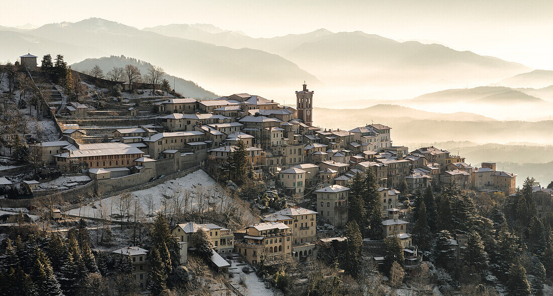 Sunrise view of the town of Santa Maria del Monte in winter from the Campo dei Fiori. Campo dei Fiori, Varese, Parco Campo dei Fiori, Lombardy, Italy.