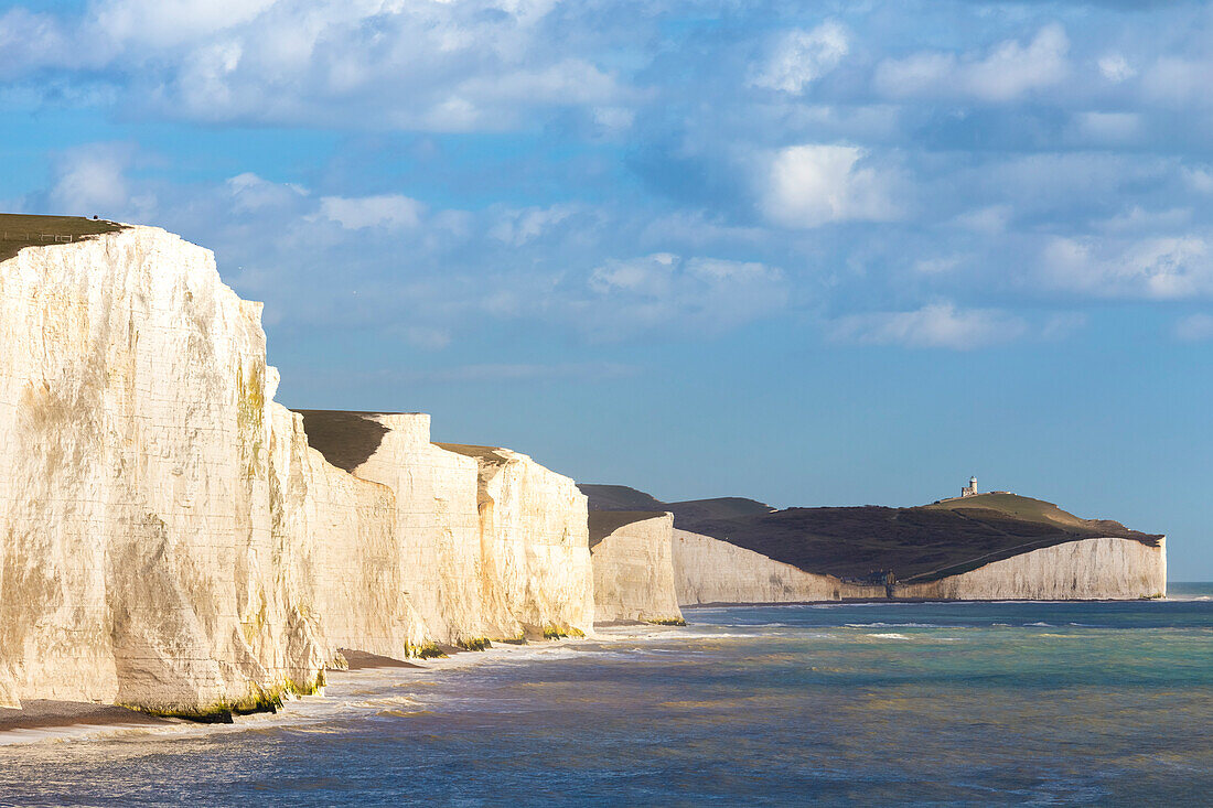 View of the Seven Sisters cliffs and the Belle Tout lighthouse, from Seaford Head across the River Cuckmere. Seaford, Sussex, England, United Kingdom.