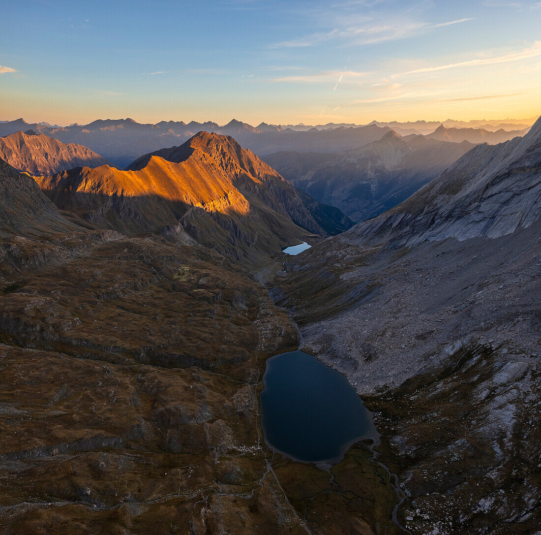 Aerial view of Lac Foreant at sunrise during summer, Col Agnel, Alpi Cozie, Cuneo, Provance, Piedmont, France, Italy, Southern Europe