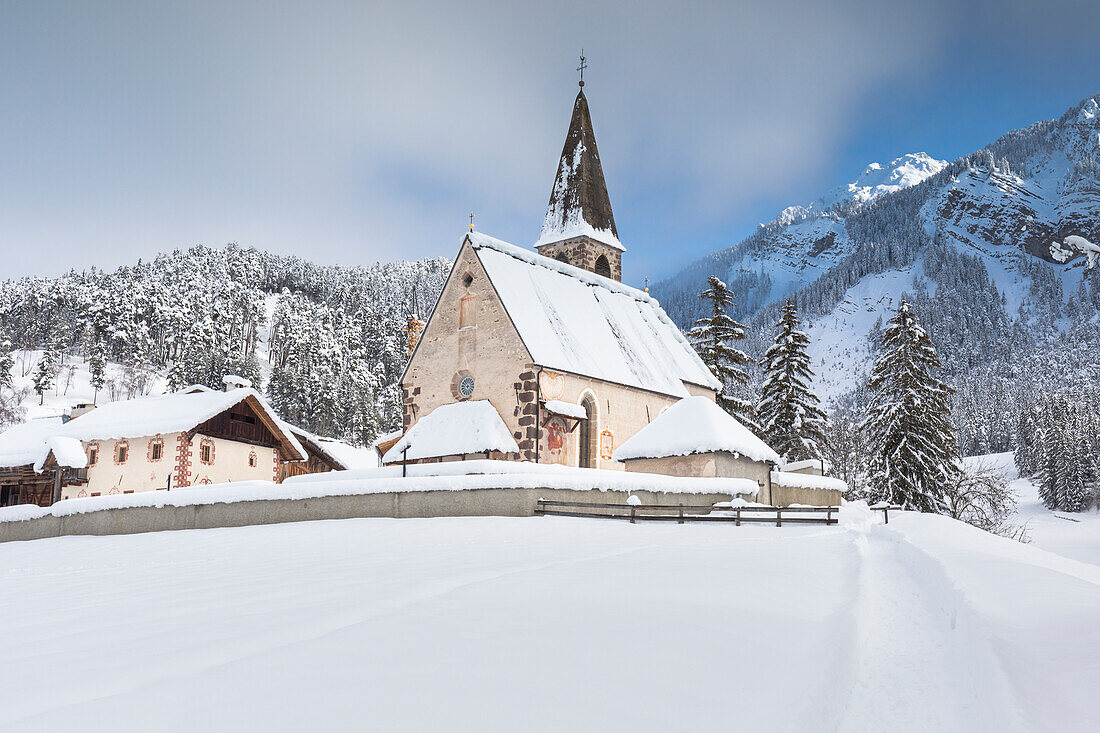 the famous little church of St. Magdalena in Villnöss after a snowfall, Bolzano province, South Tyrol, Trentino Alto Adige, Italy,