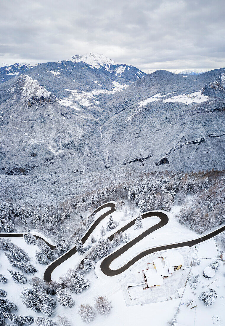 Aerial view of the winding road of the Presolana Pass and Pizzo Camino after a winter snowfall. Presolana pass, Colere, Seriana Valley, Bergamo province, Lombardy, Italy.