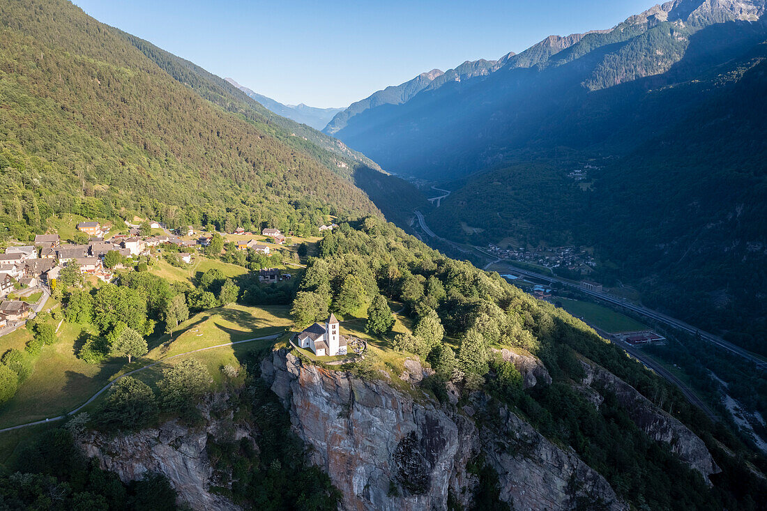 Aerial view of the church of Calonico, dominating Leventina valley towards San Gottardo pass. Calonico, district of Leventina, Canton of Ticino, Switzerland.