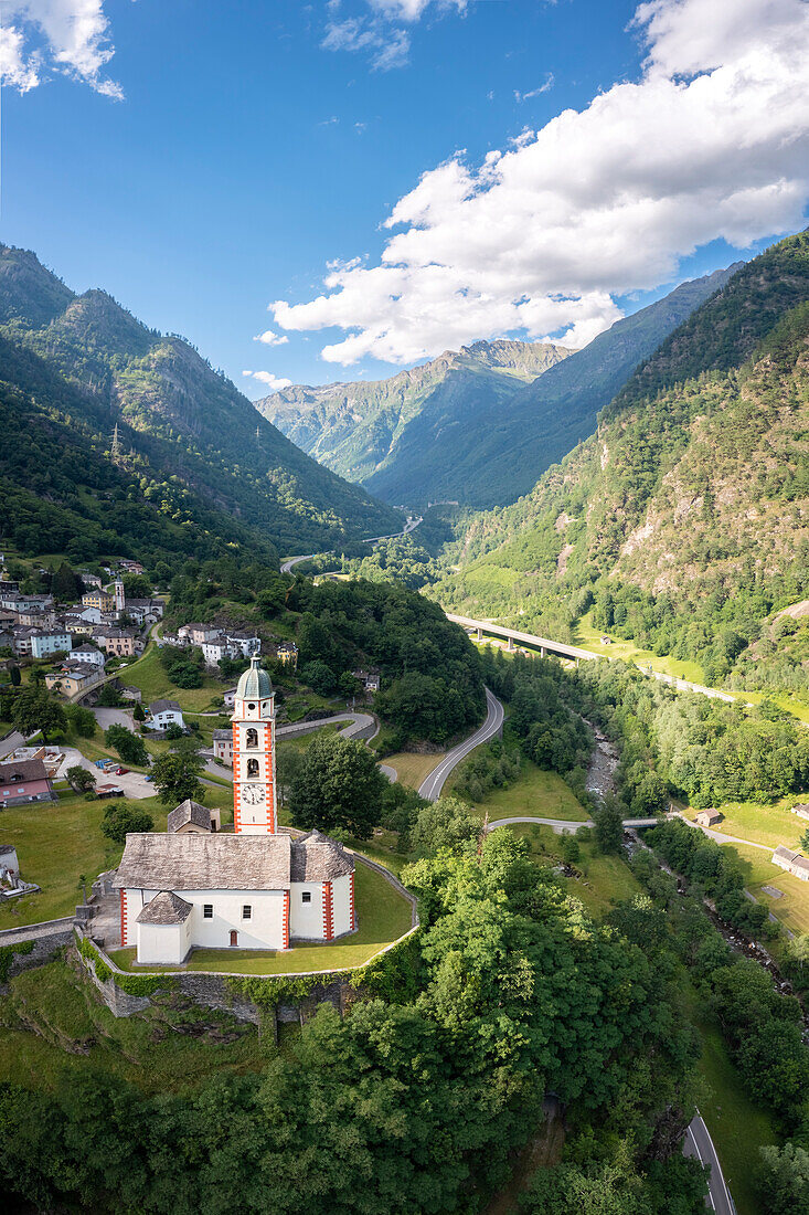 Aerial view of the San martino church of Soazza dominating the road to San Bernardino pass. Graubünden, Moesa district, Switzerland, Europe.