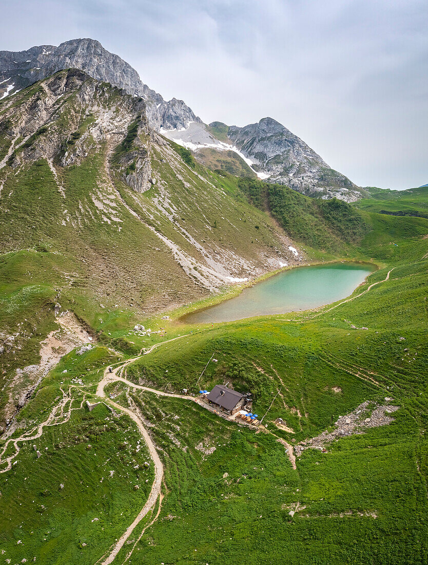 Aerial view of the Branchino lake and Rifugio Branchino during spring time. Valcanale, Ardesio, Val Seriana, Bergamo district, Lombardy, Italy, Southern Europe.