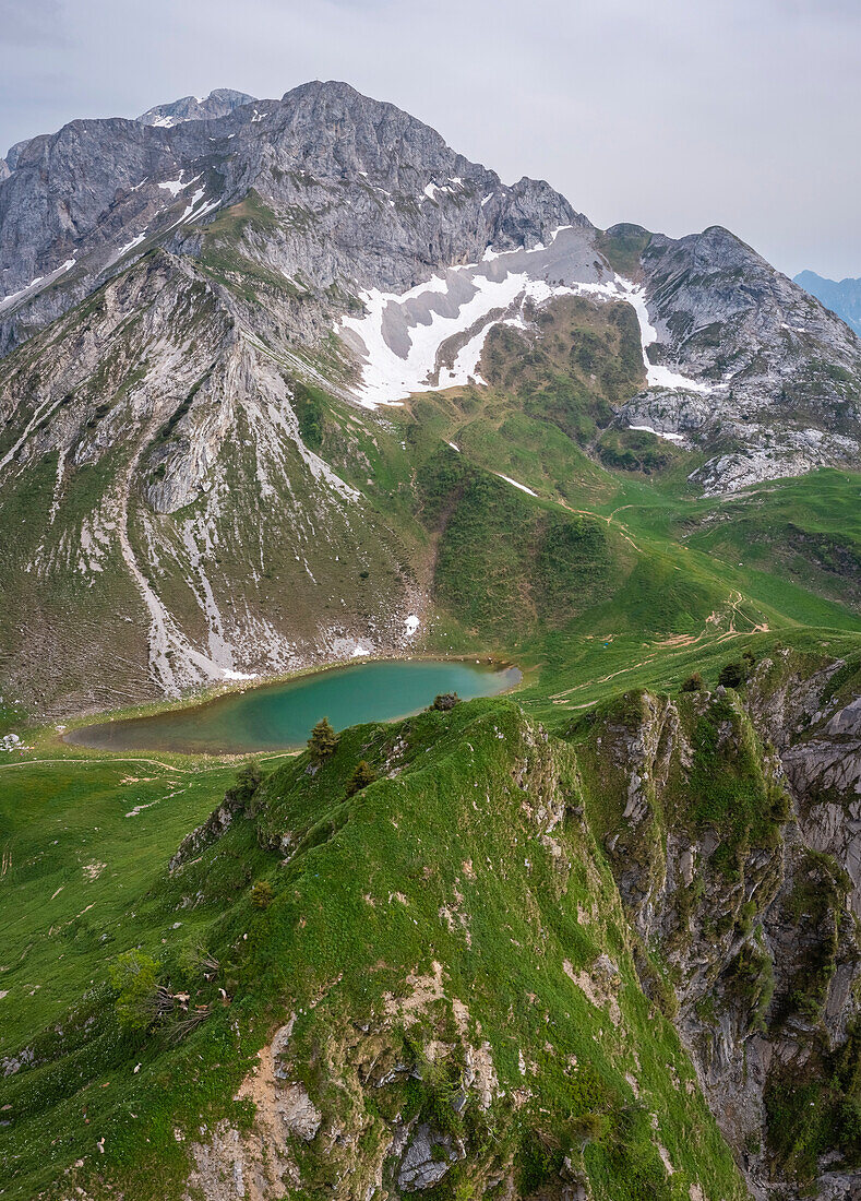 Aerial view of the Branchino lake, Corna Piana and Corno Branchino during spring time. Valcanale, Ardesio, Val Seriana, Bergamo district, Lombardy, Italy, Southern Europe.