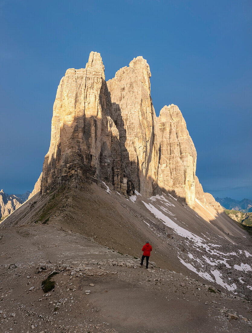 A man admiring the Tre Cime di Lavaredo at sunrise. Misurina, Auronzo di Cadore, province of Belluno, Veneto, Italy, Europe.