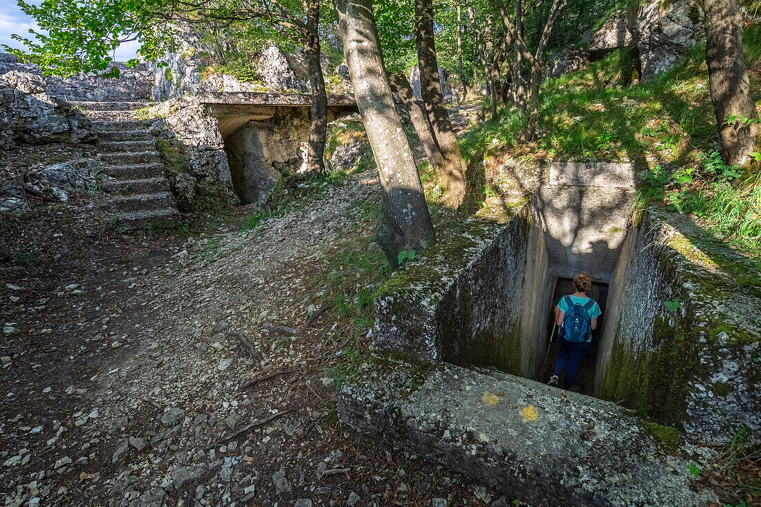 View of a trekker entering the bunkers and artillery positions inside Monte Orsa and Monte Pravello, part of the Linea Cadorna. Viggiù, Varese district, Lombardy, Italy.