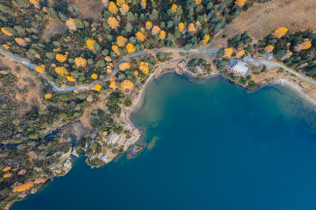 Aerial view of Cavloc Lake in autumn. Maloja Pass, Val Forno, Canton of Grisons, Engadin, Switzerland.