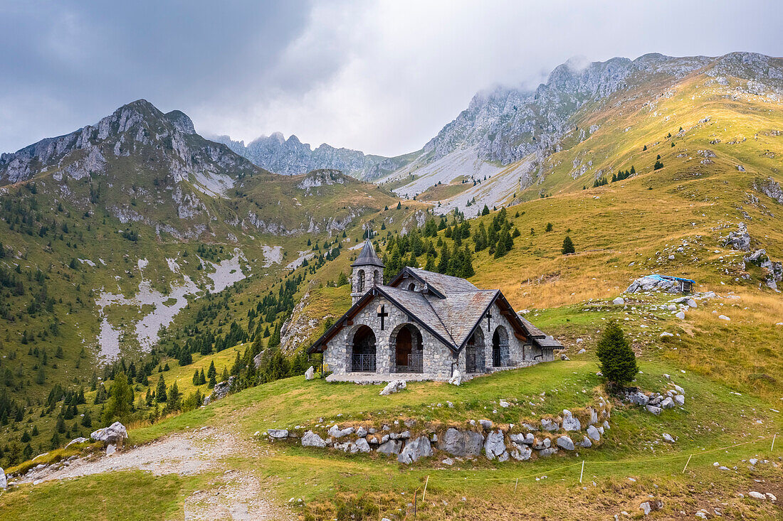 Aerial view of the Chiesetta degli Alpini church and Cima Moren of Pizzo Camino. Borno, Valcamonica, brescia district, Lombardy, Italy.