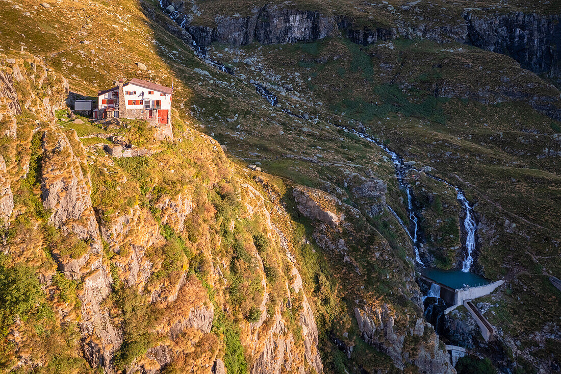 Aerial view of Rifugio Merelli al Coca on a cliff overlooking Valbondione town. Valbondione, Seriana Valley, Lombardy, Bergamo province, Italy.