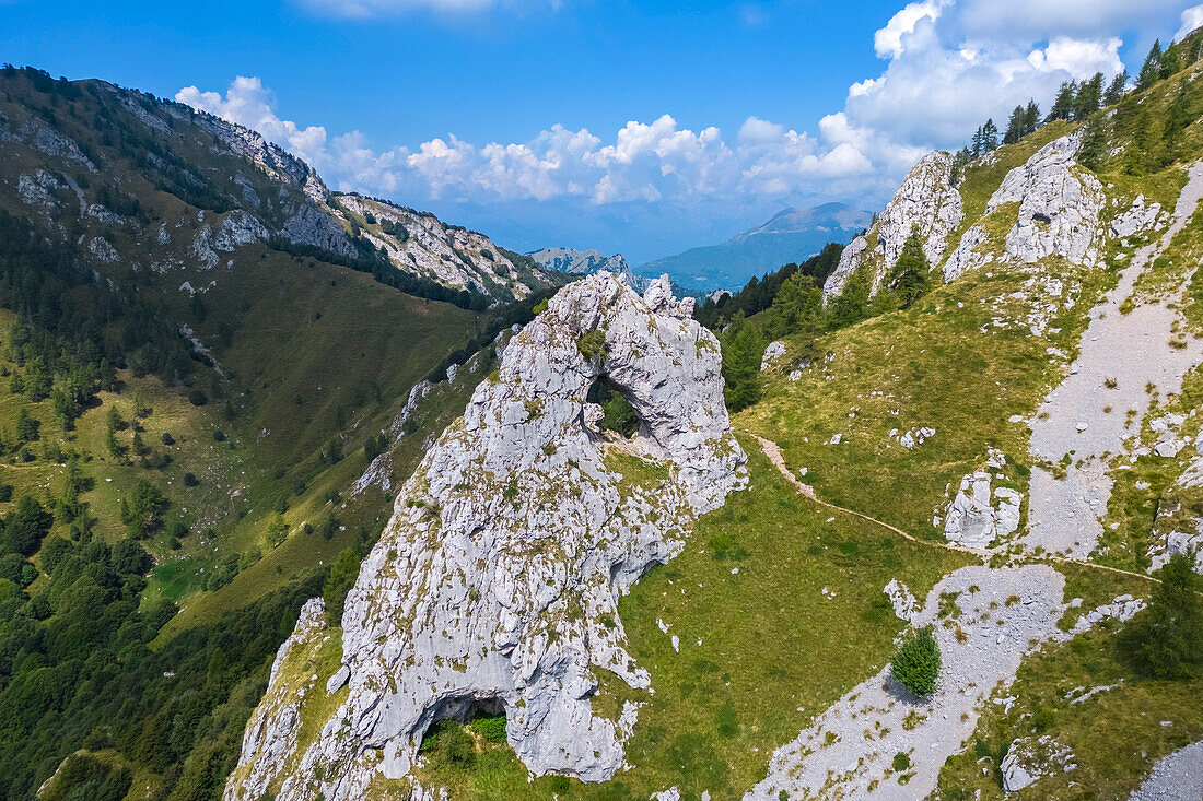 Aerial view of the natural arch rock formation called Porta di Prada in the Grigna mountain. Grigna Settentrionale, Mandello del Lario, Lombardy, Italy.