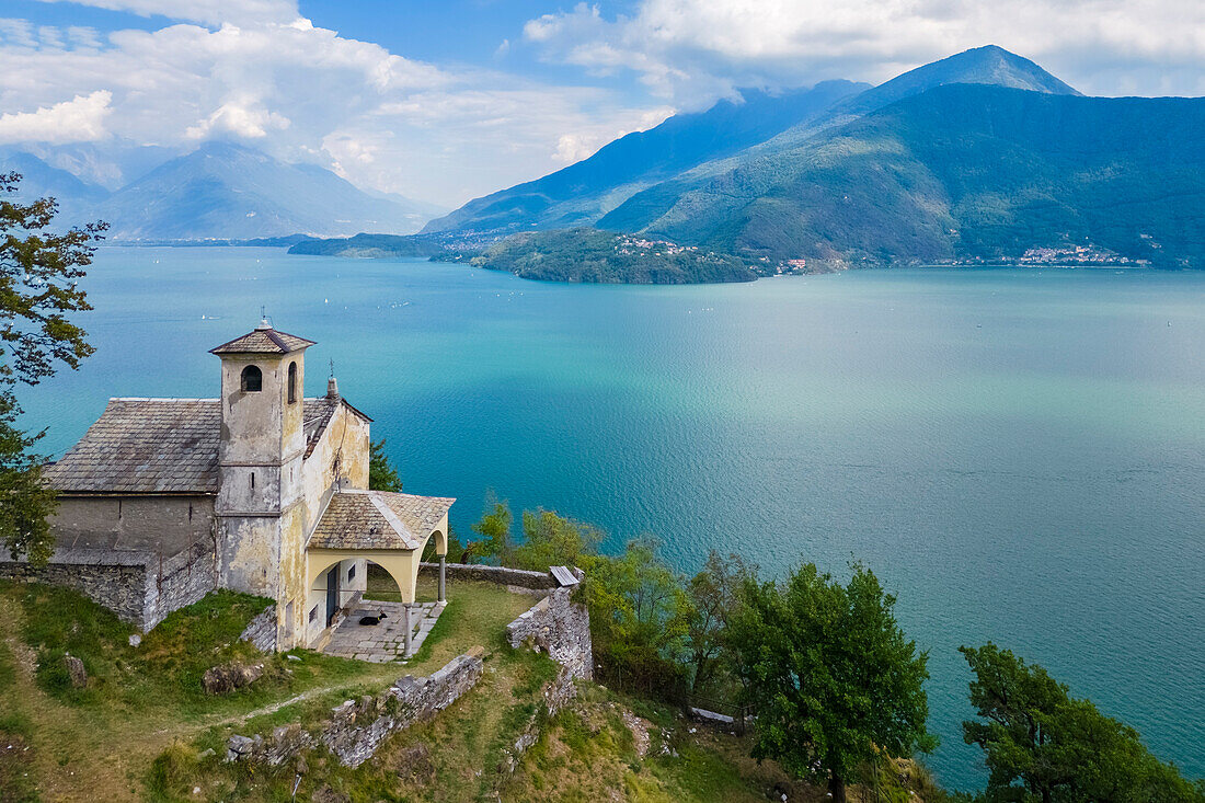 Aerial view of the church of Sant'Eufemia in Musso overlooking Lake Como. Musso, Como district, Lake Como, Lombardy, Italy