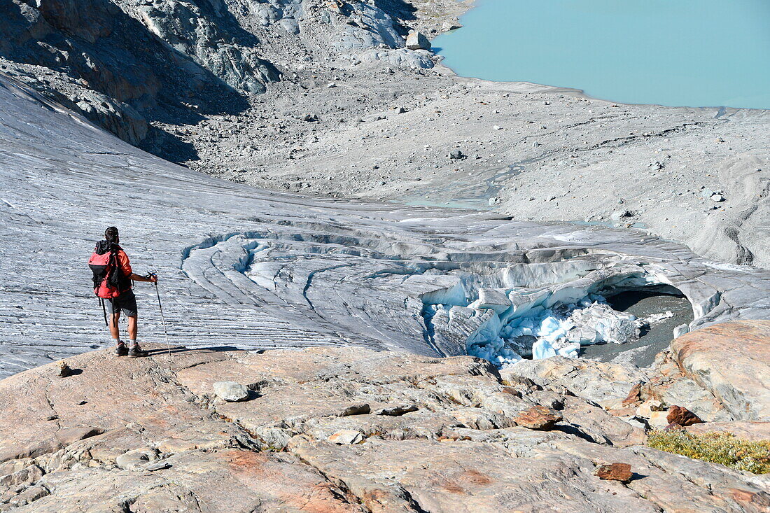 Trekker admire Rutor glacier, close to Deffeyes refuge, La Thuile valley, Aosta Valley, Italy, Europe