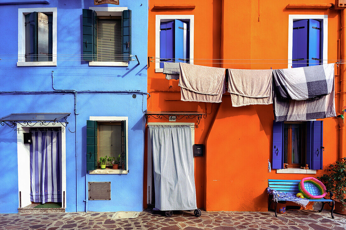 Burano, typical colored houses, orange house; blue house Burano, Venice, Veneto, Italy, south Europe.