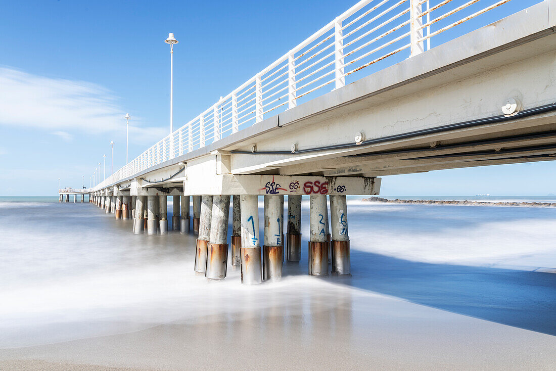 Europe, Italy, Tuscany: under a pier on Massa Carrara's seashoree