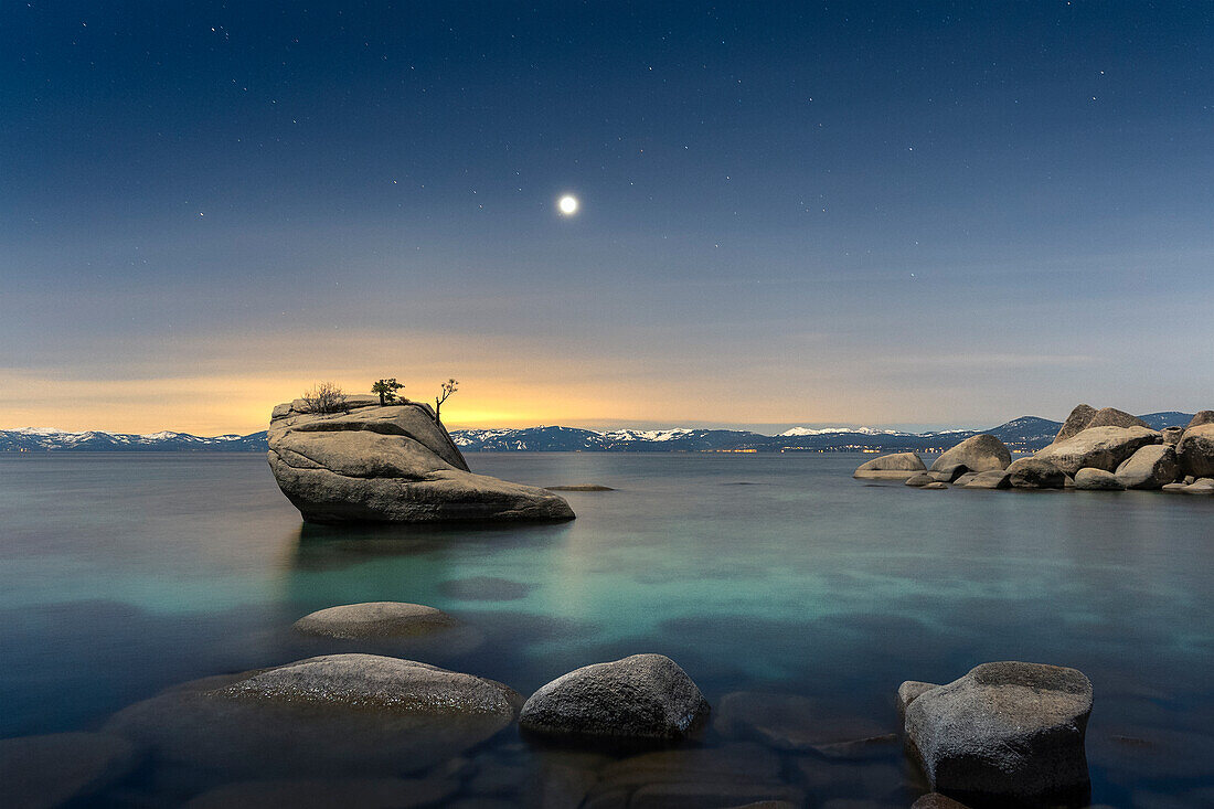 USA, Nevada, Lake Tahoe: moon rising over Bonsai Rock