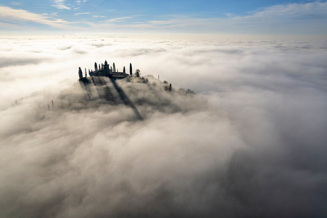 Santissima di Gussago over the clouds in Franciacorta, Brescia province in Lombardy, Italy.