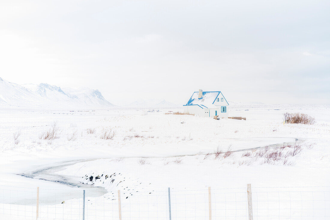 A blue house lost in the icy landscape of southern Iceland, Europe