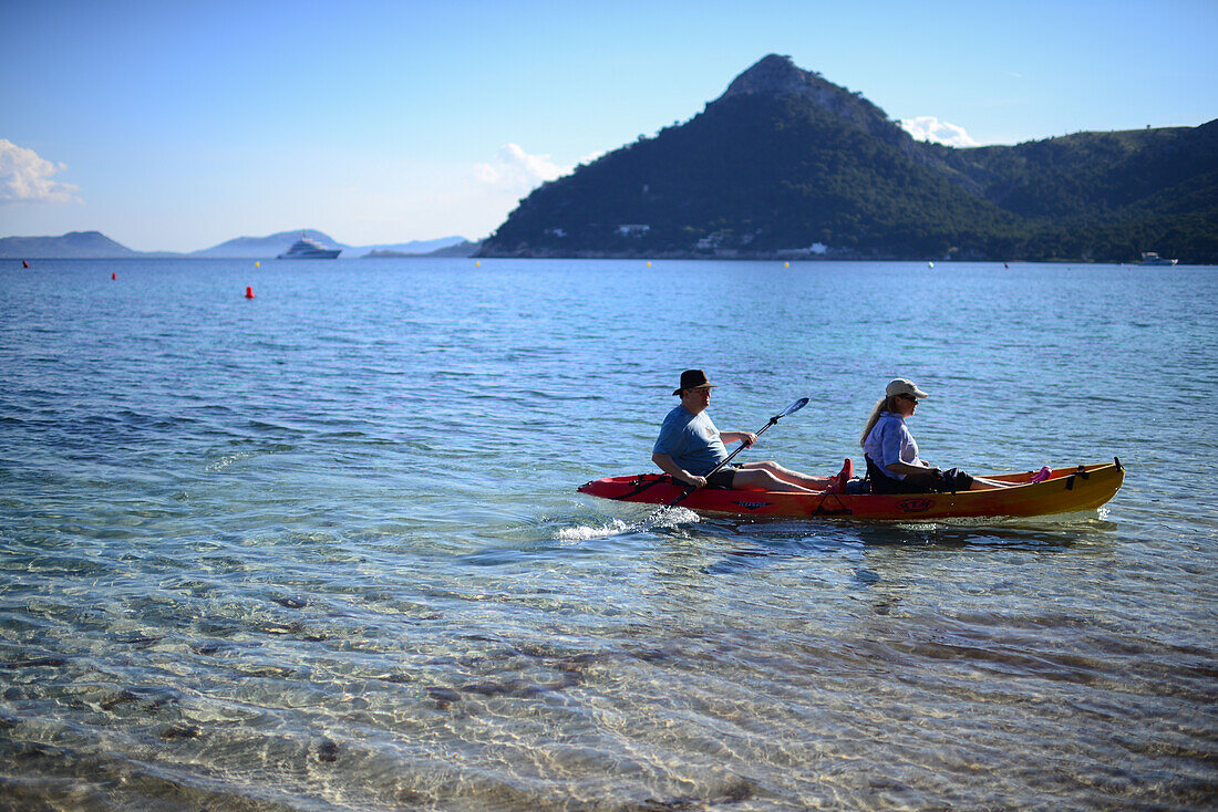 Couple kayaking on Cala Formentor beach in Mallorca, Spain