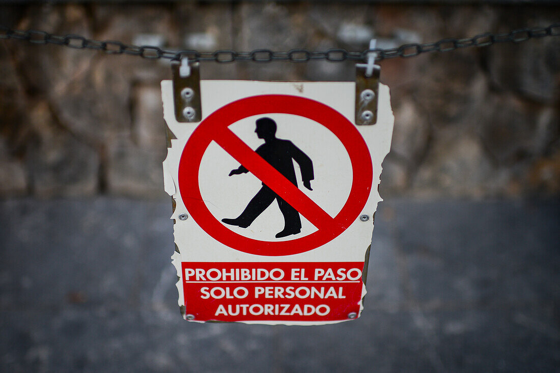 Broken sign indicates No trespassing in Spanish, only authorized personnel in Spanish, Mallorca, Spain