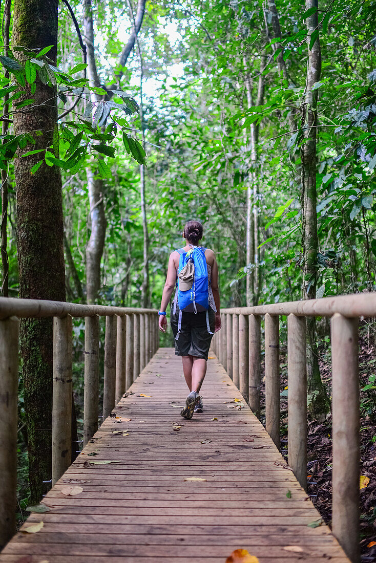 Young caucasian adventurous woman exploring Manuel Antonio National Park in Costa Rica