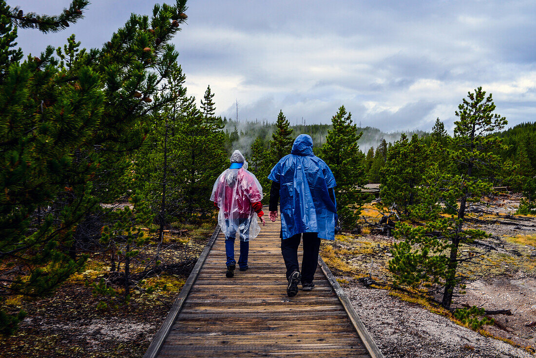 Couple of tourists in Norris Geyser Basin, Yellowstone National Park, USA
