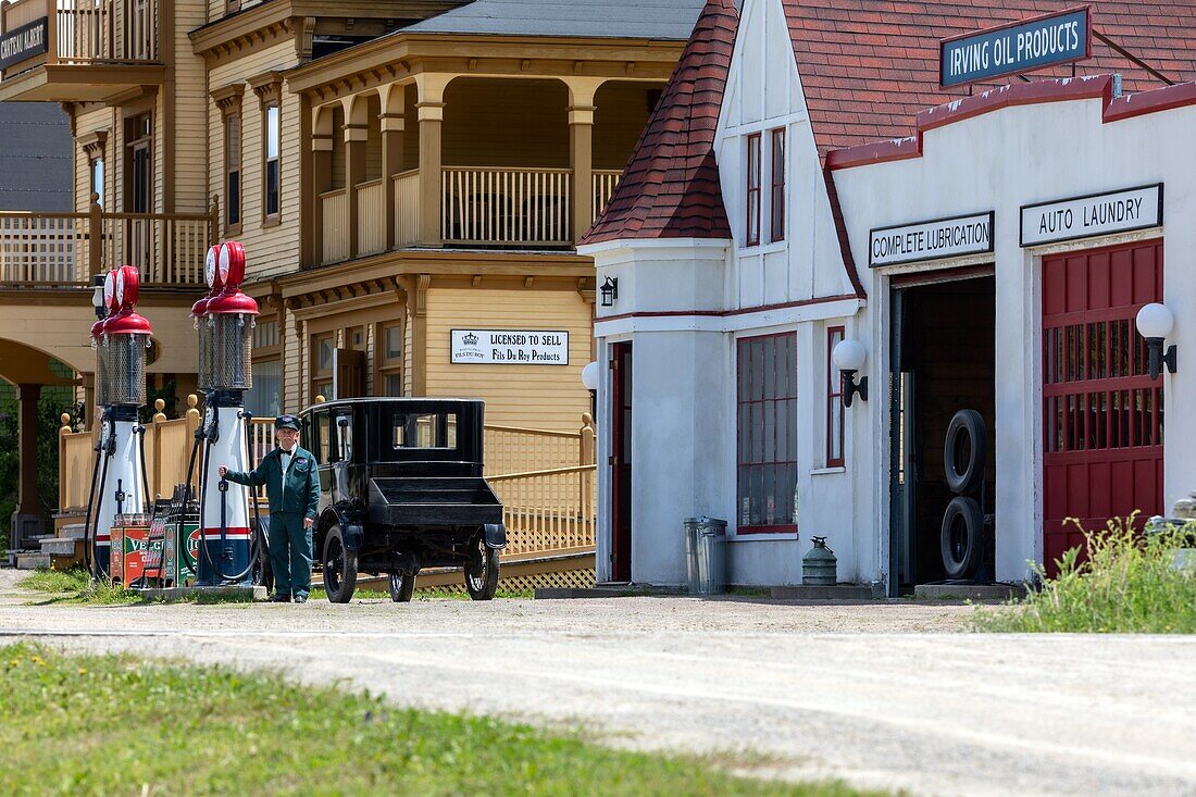 Attendant and irving oil co gas station from 1936 in front of the chateau albert hotel built in  1907, chateau albert hotel built in  1907, historic acadian village, bertrand, new brunswick, canada, north america