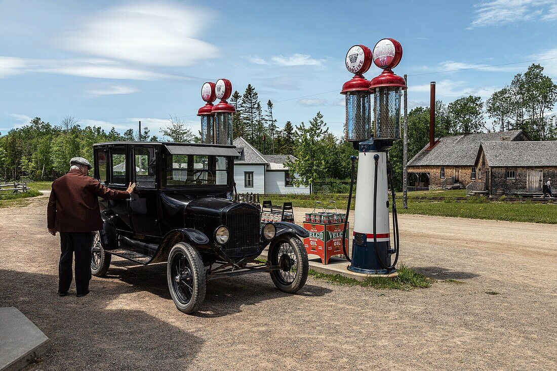 Front-wheel drive in front of the irving oil co gas station from 1936, historic acadian village, bertrand, new brunswick, canada, north america