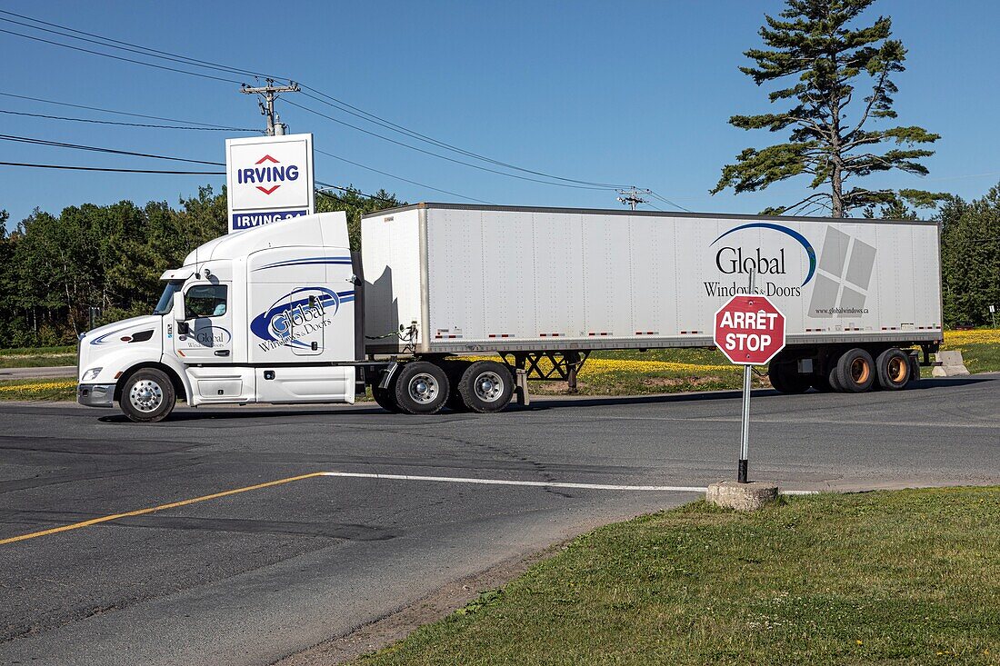 Heavy goods vehicle and a stop-arret sign in the only canadian province that is officially bilingual, moncton, new brunswick, canada, north america