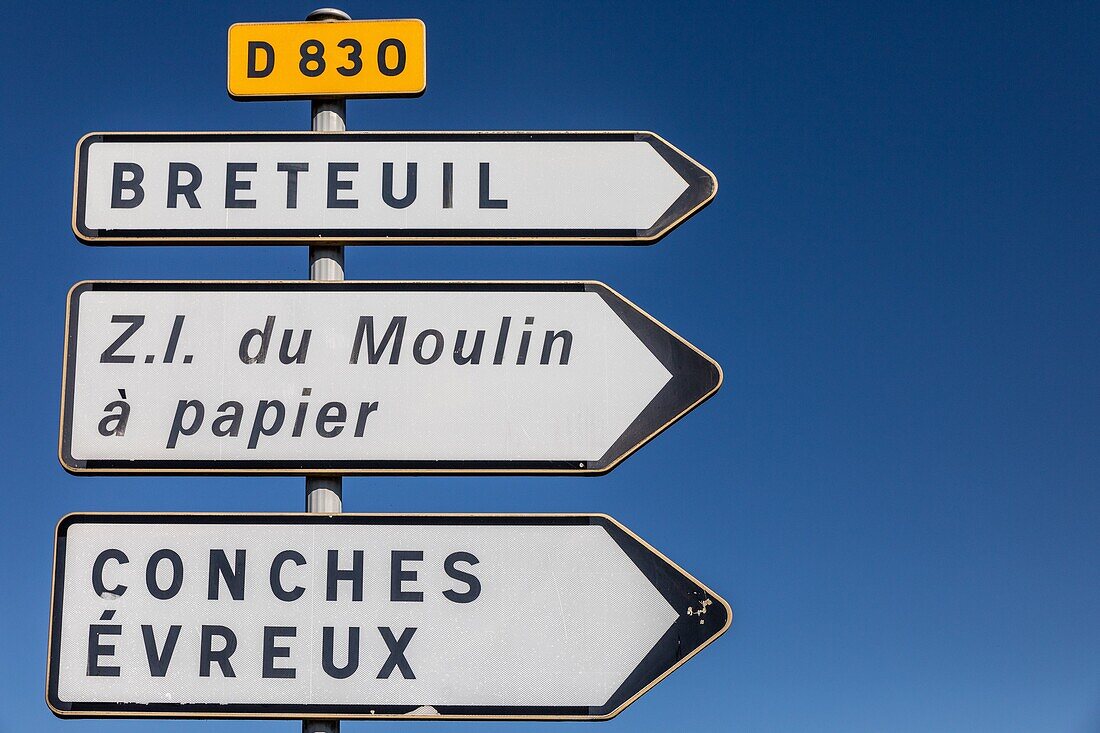 Road sign showing the different directions on the departmental road d830 with the names of the towns and the industrial zone of the moulin a papier paper mill, rugles, eure, normandy, france