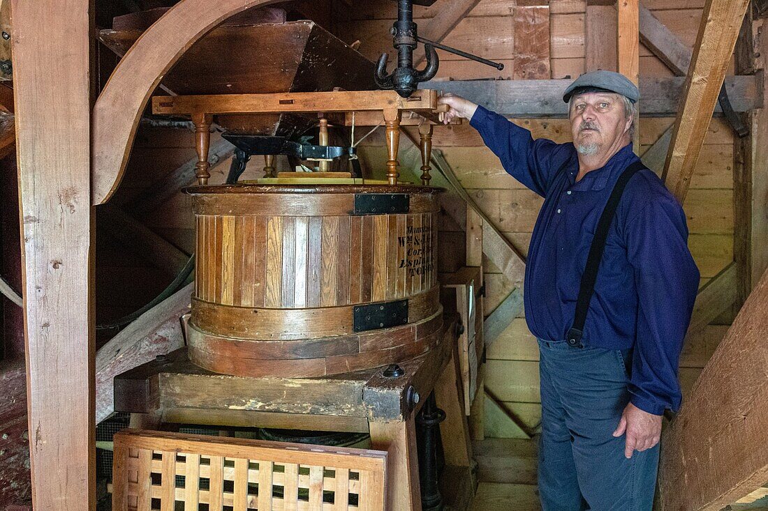 Miller in front of his wooden flour mill, kings landing, historic anglophone village, prince william parish, fredericton, new brunswick, canada, north america