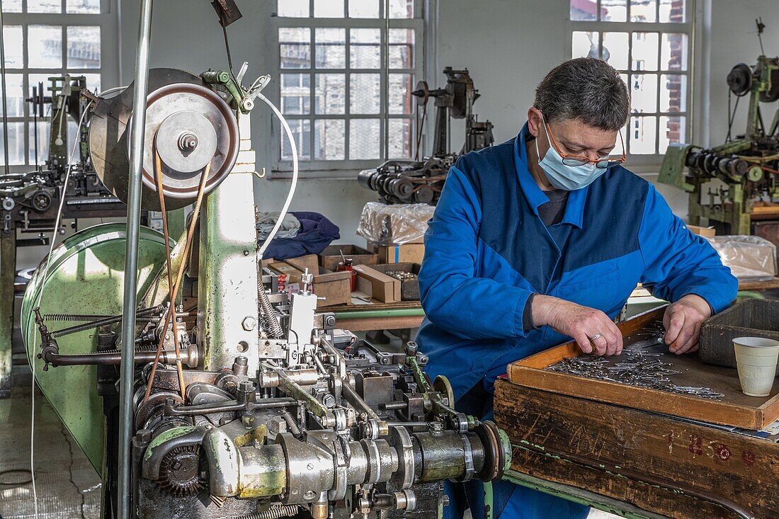 Worker making safety pins, factory of the manufacture bohin, living conservatory of the needle and pin, saint-sulpice-sur-risle, orne (61), france