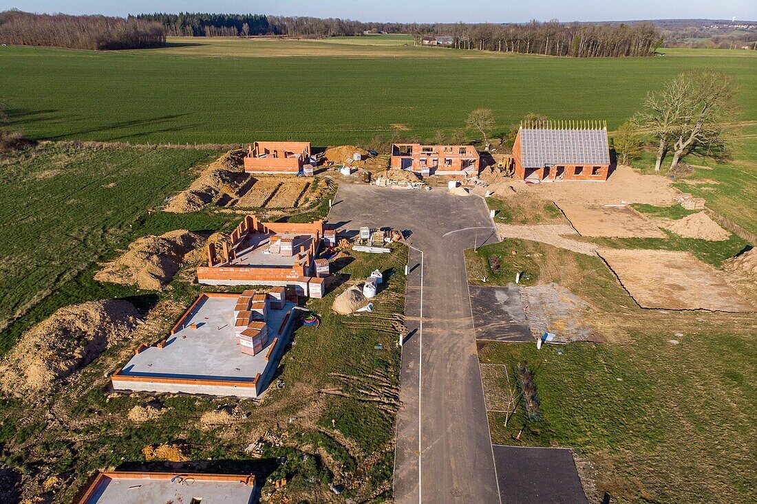 Housing development of individual homes under construction gaining ground over the farmlands, rugles, eure, normandy, france