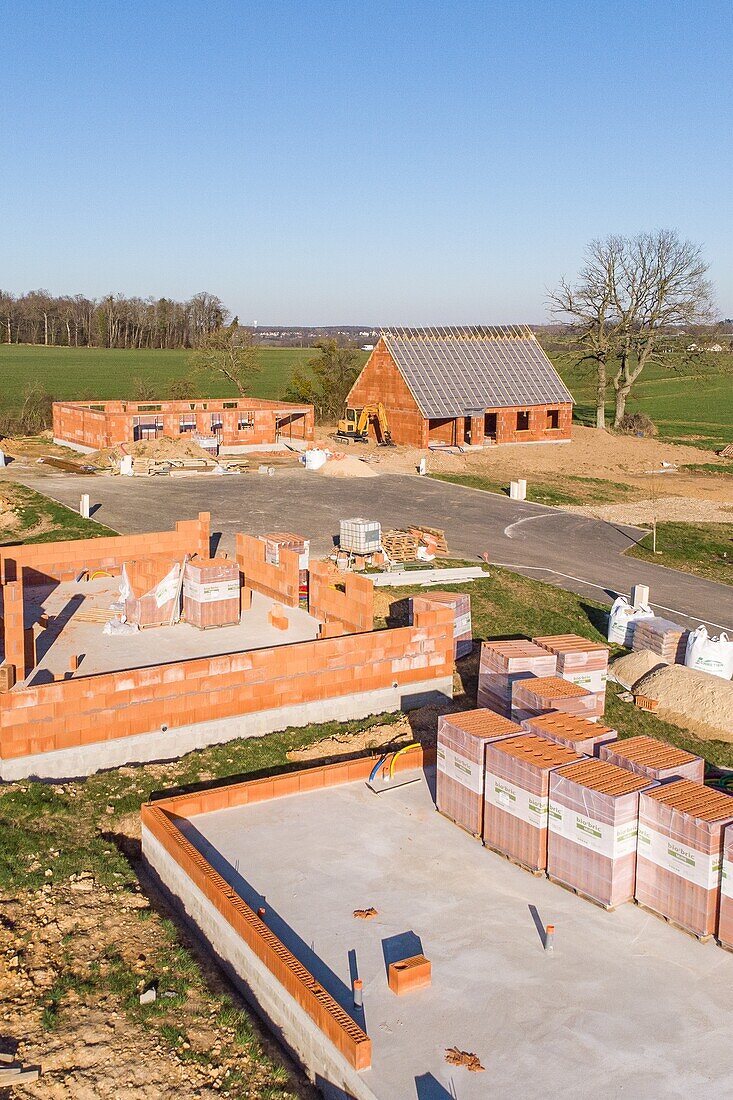 Housing development of individual homes under construction gaining ground over the farmlands, rugles, eure, normandy, france