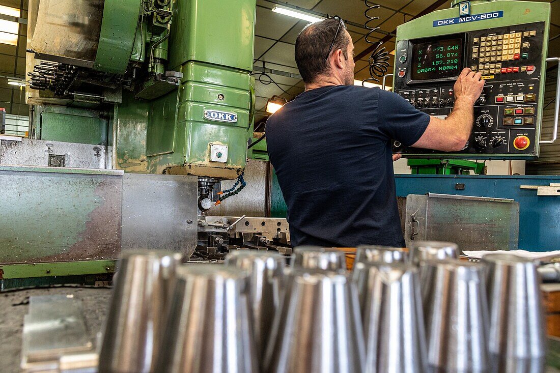 Worker with his equipment for the machining of metal parts, machining of metal parts, sma, societe mecanique aiglonne, metallurgical industry, saint-martin-d'ecublei, orne, normandy, france