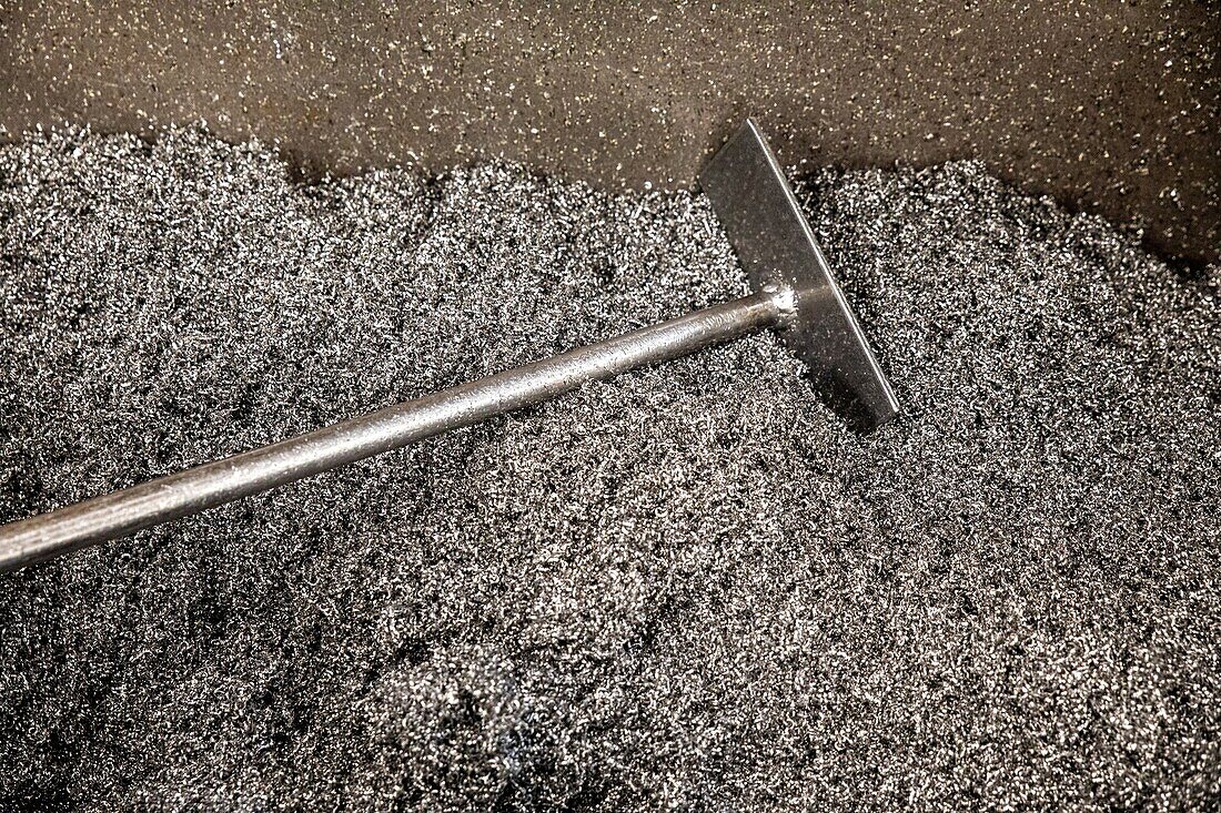 Gathering up the metal shavings after the cutting up of metal parts, l'aigle, orne, normandy, france