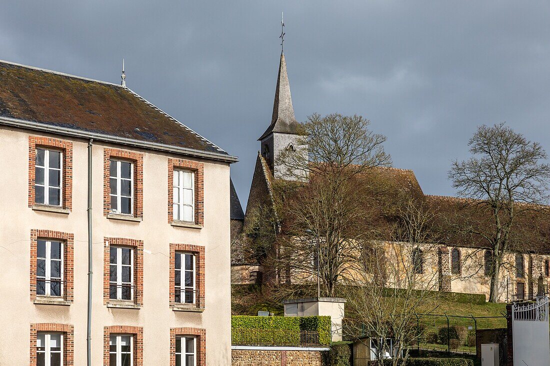 Building of the manufacture bohin factory in front of the church of saint-sulpice-sur-risle, orne, normandy, france