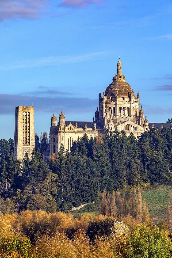 Campanile and the basilica of sainte-therese of lisieux emerging out of the country landscape, biggest basilica in france and pilgrimage site, lisieux, pays d'auge, normandy, france