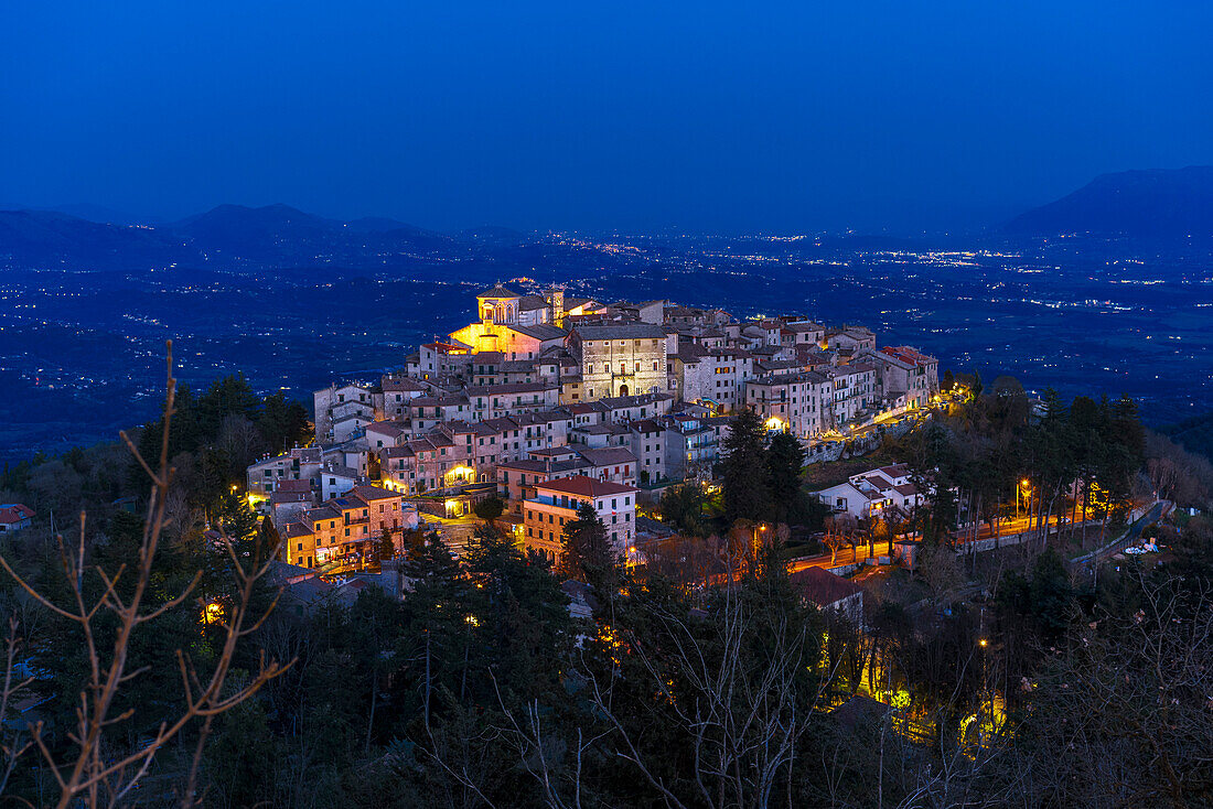 Dusk at the illuminated mountain village of Capranica Prenestina, Prenestini mountains, Rome province, Lazio, Italy