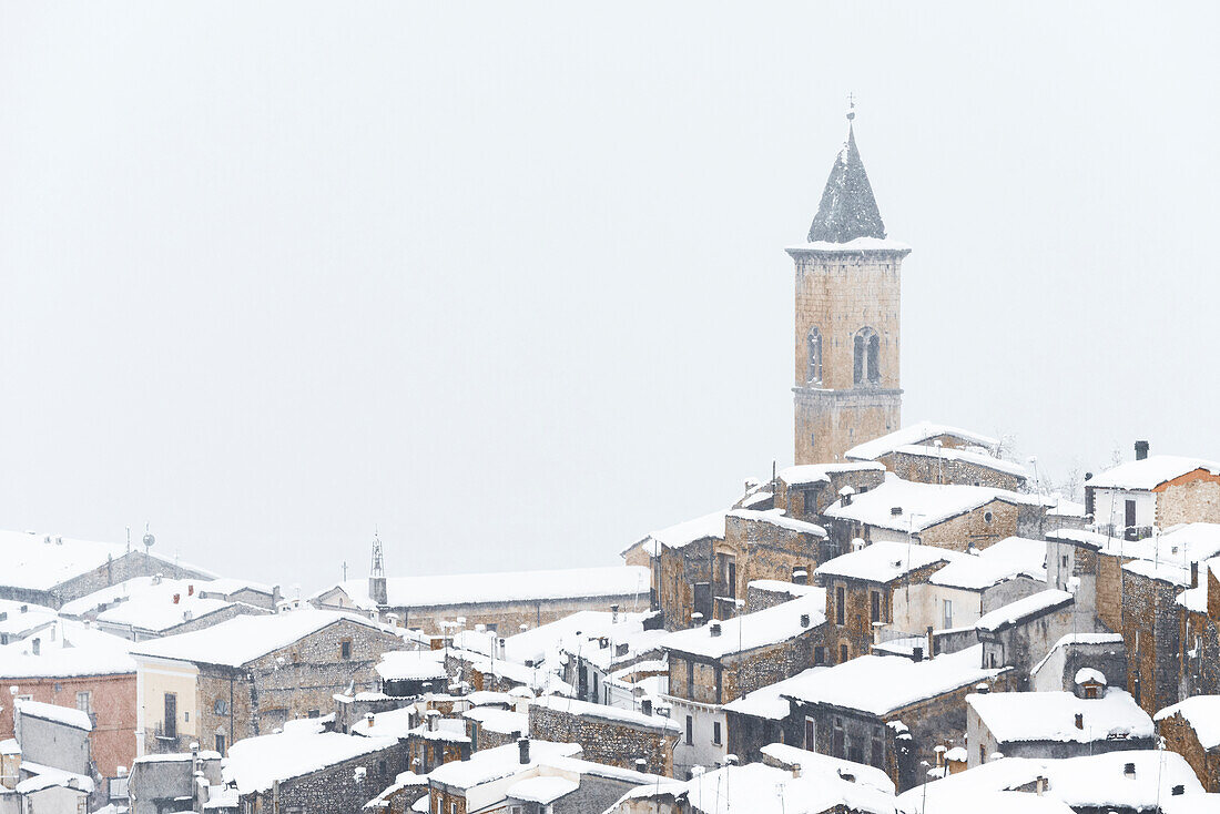 Das mittelalterliche Dorf Pacentro bei starkem Schneefall mit schneebedecktem Haus und Glockenturm, Gemeinde Pacentro, Nationalpark Maiella, Provinz L'aquila, Abruzzen, Italien