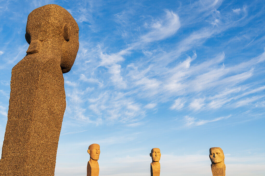 Detail of the heads of the four stone statues of Dodekalitten with the last light at sunset, Lolland island, Zealand, Denmark, Europe