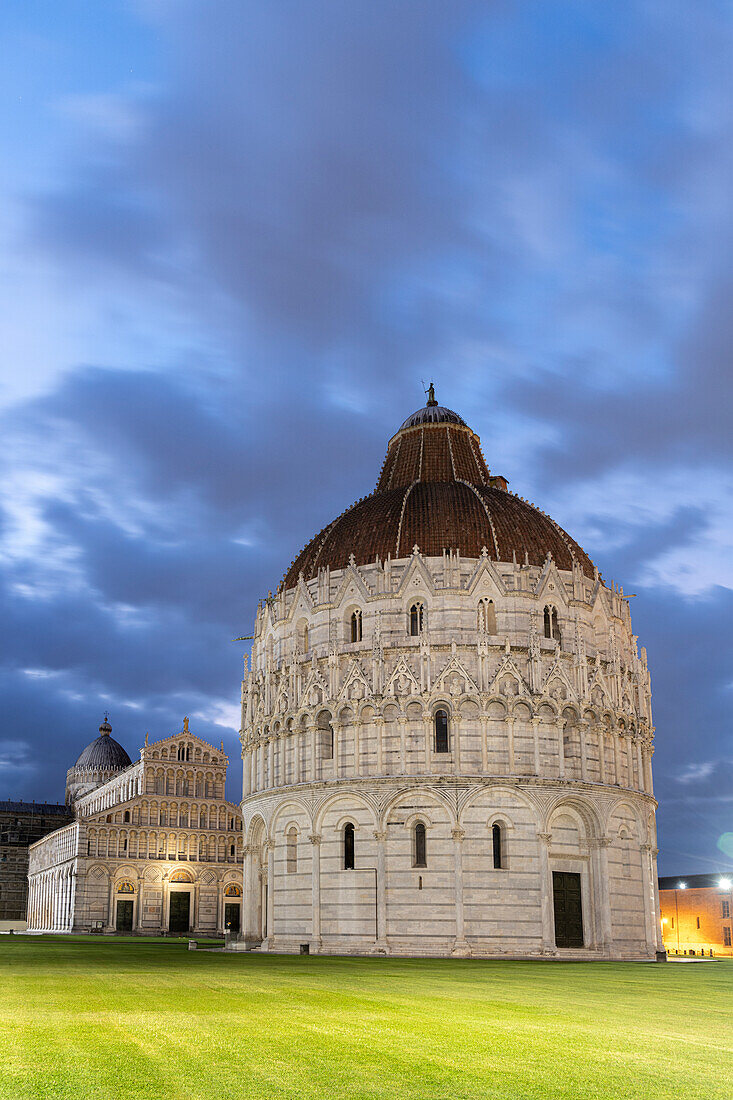 White marble of the Romanesque Pisa Cathedral (Duomo) and Baptistery lit by sunrise, Piazza dei Miracoli, Tuscany, Italy