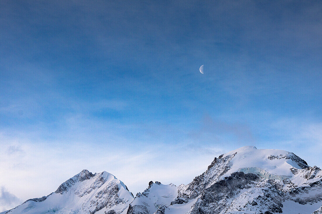 Snowy mountain ridge Biancograt on Piz Bernina and Morteratsch peak at dawn, canton of Graubunden, Engadine, Switzerland