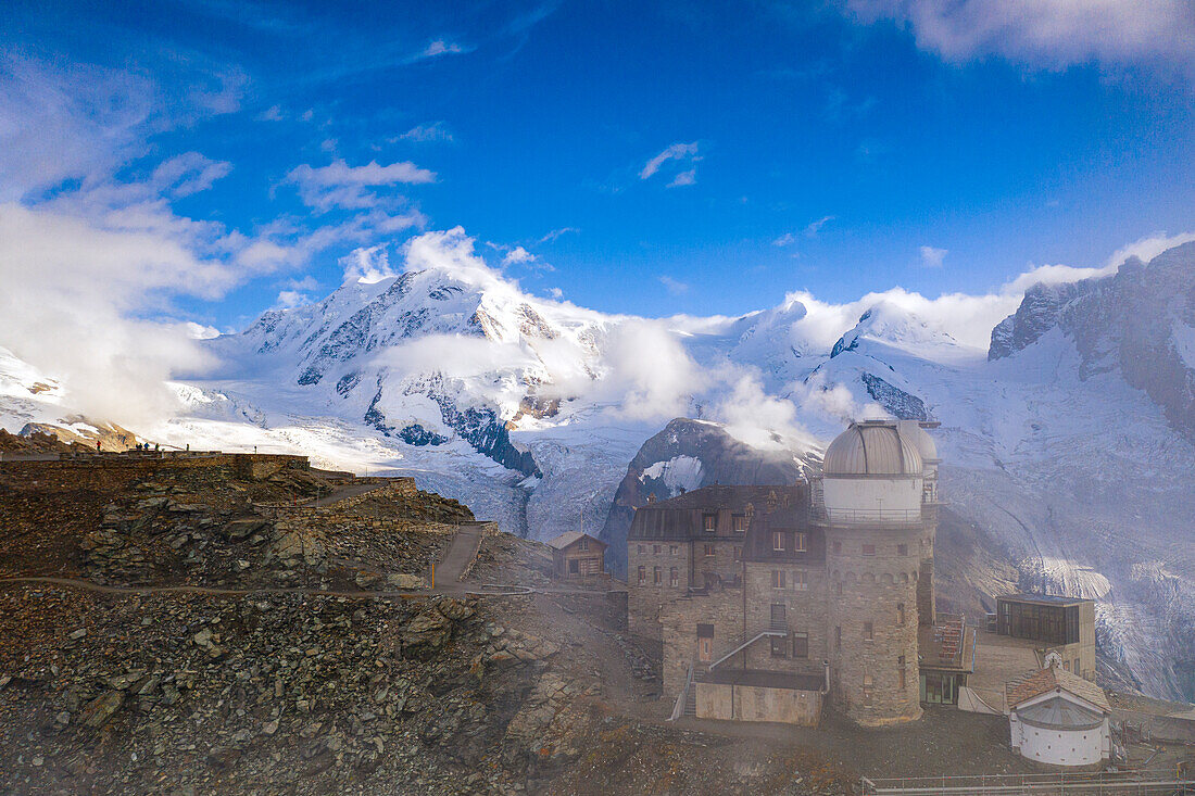 Mist over Kulmhotel Gornergrat with Lyskamm, Castor and Pollux mountains on background, Zermatt, Valais canton, Switzerland