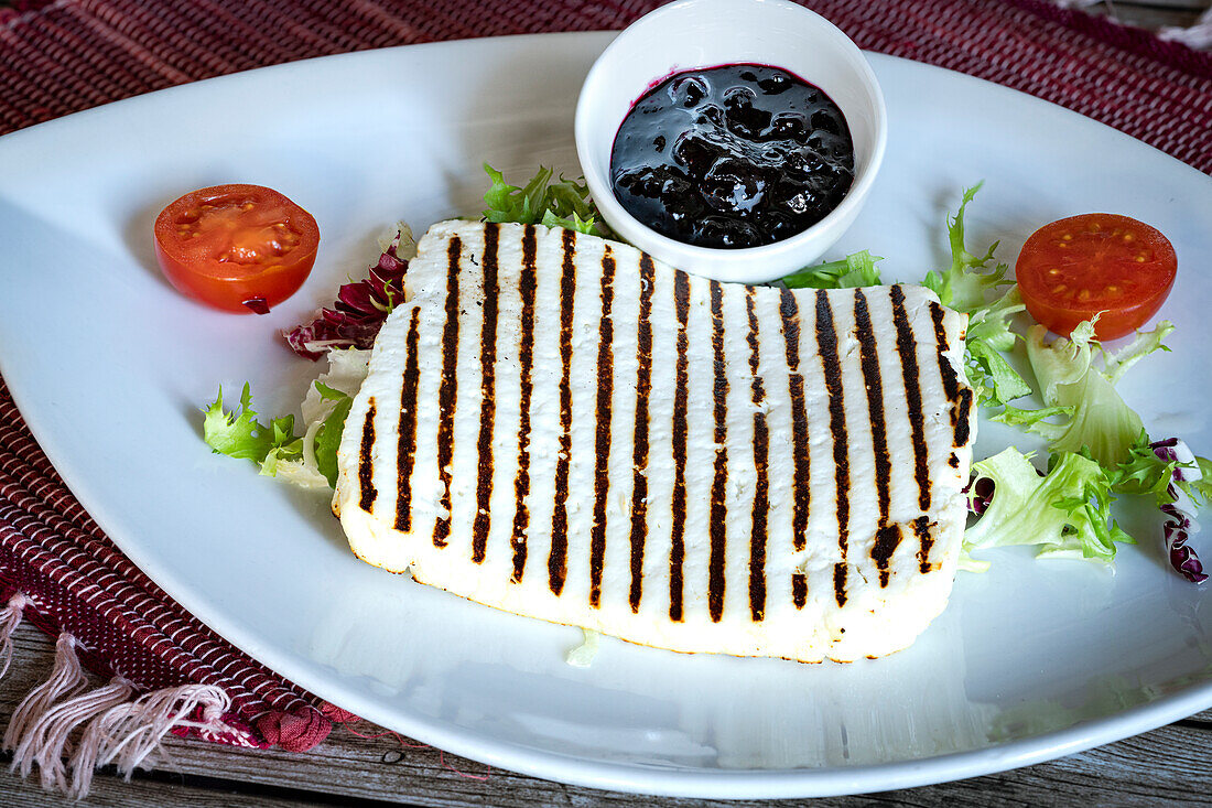 Grilled ricotta cheese with blueberries jam, typical italian appetizer
