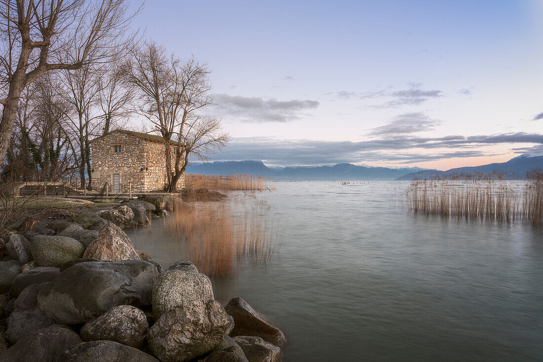 Das "Haus der Fischer" im Dorf Sirmione, am Gardasee, mit typischem Schilfdickicht, Brescia, Lombardei, Italien