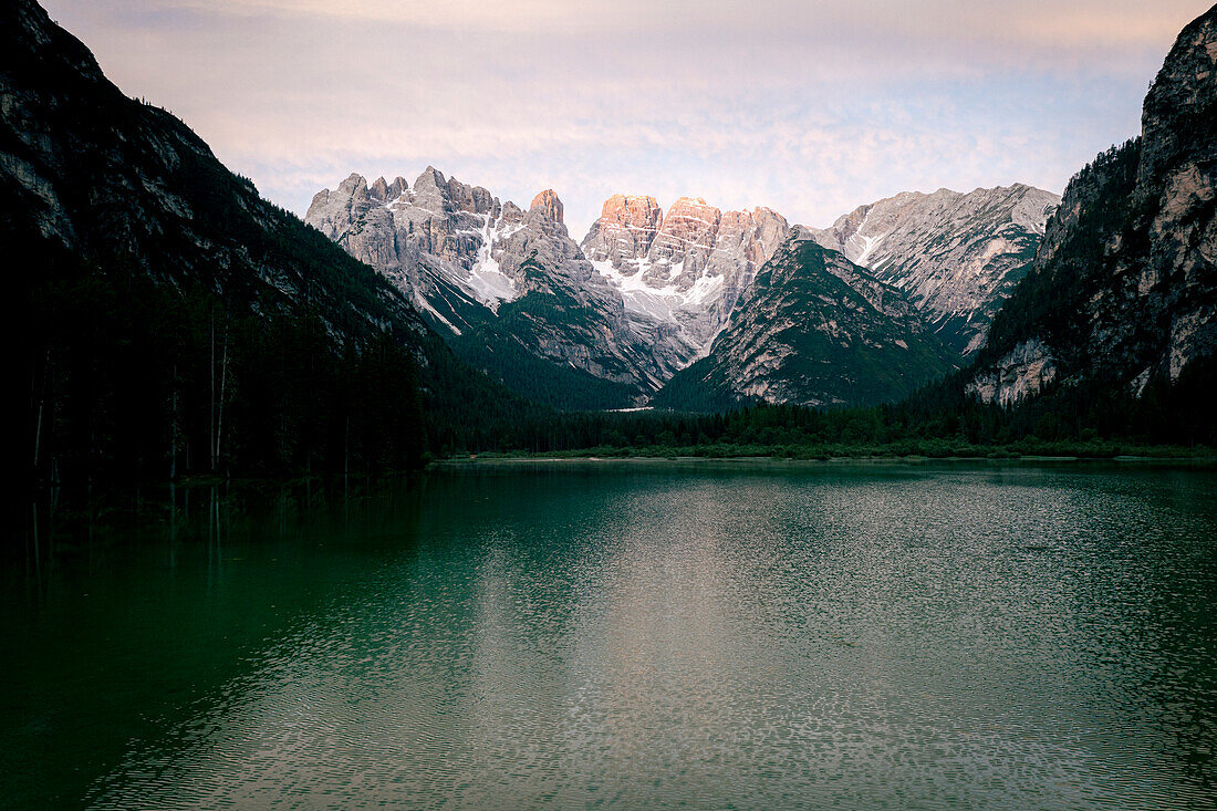 Lake Landro during a summer sunrise with Popena group and Monte Cristallo on background, Dolomites, South Tyrol, Italy