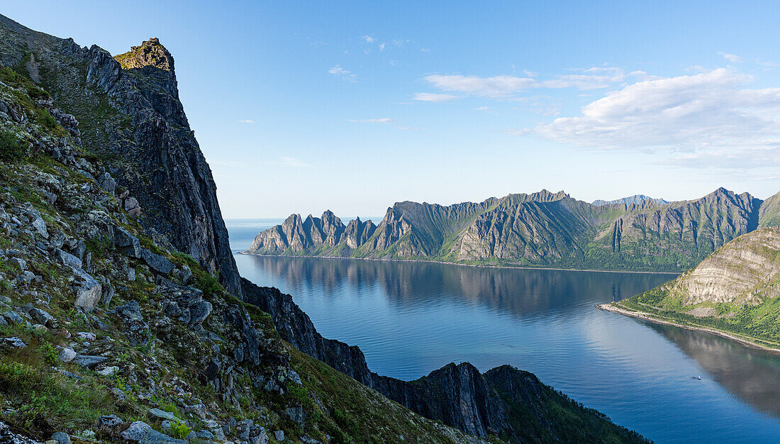 Steep ridge overlooking the fjord along the trail to Husfjellet mountain, Senja island, Troms county, Norway