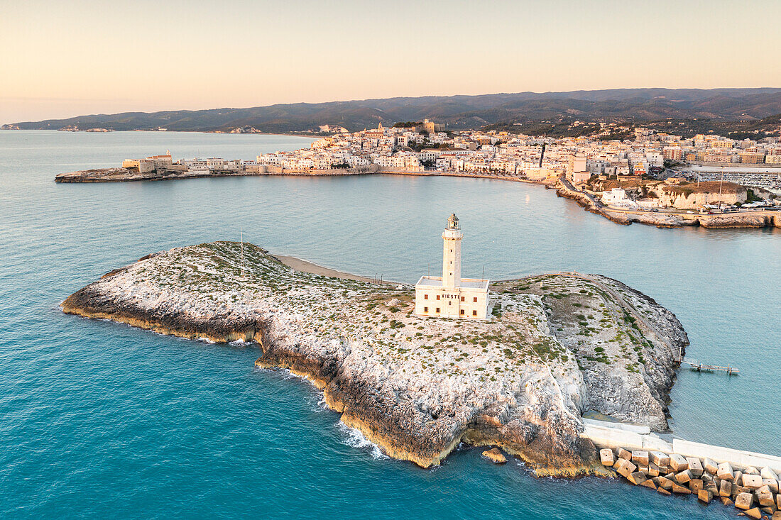 Aerial view of Vieste lighthouse on Sant'Eufemia islet by the sea, Foggia province, Gargano National Park, Apulia, Italy